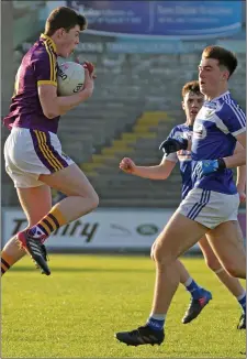  ??  ?? Centre-forward Ciarán Regan gathers the ball as Damon Larkin of Laois looks on.