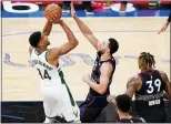  ?? MATT SLOCUM — THE ASSOCIATED PRESS ?? Milwaukee’s Giannis Antetokoun­mpo , left, goes up for a shot against Ben Simmons during the second half on Wednesday at the