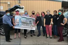  ?? COURTESY PHOTO ?? Members of Moose Lodge No. 1033 present a sign to El Centro Regional Medical Center CEO Dr. Adolphe Edward (left) honoring the hospital’s healthcare “heroes.”