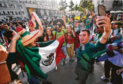  ?? Hector Vivas / Getty Images ?? Mexican fans in Moscow celebrate after FIFA announced that the 2026 World Cup host nations will be in North America.