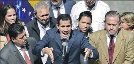  ?? — GETTY IMAGES ?? Venezuela’s opposition leader and self-proclaimed acting president Juan Guaido, centre, speaks to the press Monday.