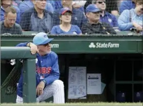  ?? NAM Y. HUH — THE ASSOCIATED PRESS ?? Chicago Cubs manager Joe Maddon watches his team during the third inning of a baseball game against the Cincinnati Reds, Friday in Chicago. The Cubs keep winning through everything that knocks some contenders out of the playoff race.