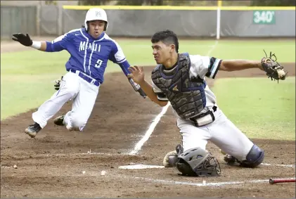  ?? The Maui News / MATTHEW THAYER photos ?? Maui High School’s Nakoa Benjamin scores a run as an errant throw gets past King Kekaulike catcher Kamakalei Stone during the sixth inning of the Sabers’ 8-4 win over Na Alii in a Maui Interschol­astic League Division I tournament semifinal Friday evening at Maehara Stadium.