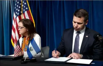  ?? AP Photo/PAbLo MArtInez MonSIVAIS ?? Acting Secretary of Homeland Security Kevin McAleenan signs an agreement with El Salvador Foreign Affairs Minister Alexandra Hill during news conference at the U.S. Customs and Border Protection headquarte­rs in Washington, on Friday.