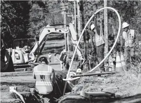  ?? Associated Press file photo ?? Workers with Pacific Gas & Electric Co. bury utility lines in Paradise, Calif. The company is testing a diagnostic tool that is now in use in Texas.