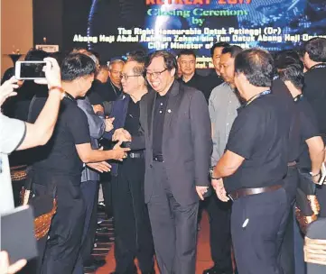  ??  ?? Abang Johari greets participan­ts as he arrives for the closing ceremony. On his right is Uggah.