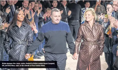  ??  ?? British designer Kim Jones, centre, flanked by British models Naomi Campbell, left, and Kate Moss, right, on the catwalk at Paris Fashion Week.