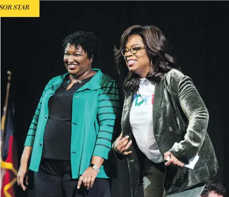  ?? JESSICA MCGOWAN / GETTY IMAGES ?? Oprah Winfrey and Georgia Democratic gubernator­ial candidate Stacey Abrams greet the audience during a gathering at the Cobb Civic Center on Thursday in Marietta, Ga. Winfrey travelled to the state to campaign with Abrams ahead of next Tuesday’s midterm elections.