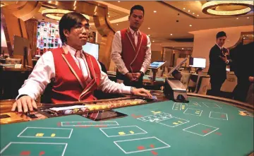  ??  ?? Employees inside the casino prepare for the opening of MGM Cotai in Macau. — Reuters/Bloomberg photos