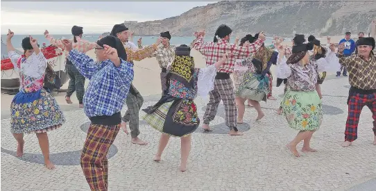  ?? RICK STEVES ?? Along the beach, local folk music groups dance proudly for visitors to Nazare, a fishing town two hours north of Lisbon.