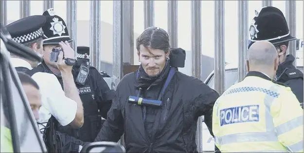  ?? Picture: Dan Phillips ?? Undercover police officer Mark Kennedy, aka Mark Stone, is led away from Hartlepool Nuclear Power Station after infiltrati­ng a green protest group