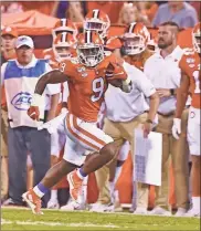  ??  ?? Clemson’s Travis Etienne runs down the sideline for a 90yard touchdown during the first half of the team’s NCAA college football game against Georgia Tech in Clemson, S.C. on Aug. 29.