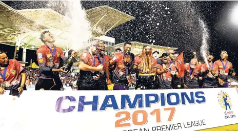  ?? RANDY BROOKS CWI PHOTO VIA GETTY IMAGE ?? Trinbago Knight Riders celebrate winning the Finals of the 2017 Hero Caribbean Premier League between Trinbago Knight Riders and St Kitts & Nevis Patriots at the Brian Lara Cricket Academy last Saturday in Tarouba, Trinidad.