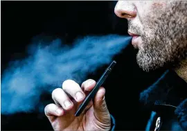  ?? JEENAH MOON / NEW YORK TIMES ?? Public health officials have recommende­d that people consider refraining from vaping while they investigat­e hundreds of cases of lung illness and six deaths linked to e-cigarettes. On Wednesday, Trump administra­tion officials said they would move toward a ban on the sale of most flavored e-cigarettes.