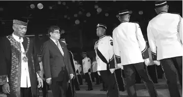  ??  ?? Abang Johari (second left) inspecting the guard of honour at the launching ceremony of the 29th Kuching City Day Celebratio­n at Stadium Perpaduan. Accompanyi­ng him are Abang Abdul Wahap (left) and Chan (partly hidden). — Photo by Chimon Upon