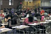  ??  ?? CRUNCH TIME: Some 300 PSAT test-takers are packed elbow-to-elbow at DeWitt Clinton HS.