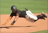 ?? ABBIE PARR — GETTY IMAGES ?? The San Francisco Giants’ Heliot Ramos dives safely into second base in the eighth inning against the Oakland Athletics at Scottsdale Stadium on Sunday in Scottsdale, Ariz.