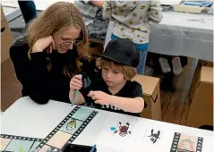  ?? AUCKLAND ART FAIR ?? Visitors of all ages are encouraged to get creative at the Squiggla stand.