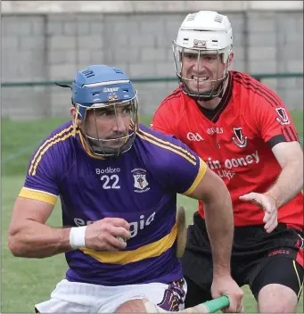  ??  ?? Stephen Ryan of St. Patrick’s is closed down by Oulart-The Ballagh defender Ian Storey.