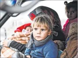  ?? The Associated Press ?? Syrian civilians flee Thursday from Idlib to find safety near the border with Turkey. The U.N. said children make up the majority of the Syrians displaced since Dec. 1.