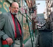  ?? Democrat-Gazette file photo ?? Beat poet Allen Ginsberg stands in Jack Kerouac Alley next to the City Lights Bookstore in San Francisco in 1994.