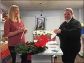  ?? PHOTO COURTESY OF JEFF CRONIN ?? Jenna Naffin, left, assistant show manager of the Philadelph­ia Home and Garden Show, works with Cameron Peters, right, prepping the borough’s wreaths in Peters’ shop.