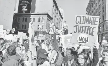  ?? photo — Reuters ?? Young people protest outside of the San Francisco Federal Building during a Climate Strike march in San Francisco, US. Almost 90 big companies in sectors from food to cement to telecommun­ications are pledging to slash their greenhouse gas emissions in a new campaign to steer multi-nationals towards a low-carbon future, organisers said.