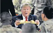  ??  ?? Donald Trump, the US president, serves Thanksgivi­ng dinner to US troops at Bagram air field in Afghanista­n