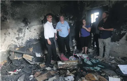  ?? J A A FA R A S H T I Y E H / A F P/ G E T T Y I MAG E S ?? Israeli peace activists stand in the Dawabsheh family home set on fire by suspected Jewish extremists and where a Palestinia­n toddler was burned to death on Aug. 2 in the West Bank village of Duma. The firebombin­g sparked an internatio­nal outcry over...