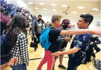  ?? ?? Students congratula­te Joaquin Martinez after the assembly where he received a Golden Apple Award on Tuesday.