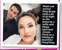  ??  ?? Model and actress Kelly Brook looks a bit of all flight as she poses for a selfie with Italian boyfriend Jeremy Parisi on a holiday jet bound for Hong Kong.
