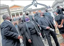  ?? MATT STONE / BOSTON HERALD ?? A group of Black religious leaders lobby in front of the Statehouse in July in favor of police reform legislatio­n.