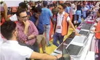  ?? Photos by Shihab ?? Customers check laptops at the ongoing Gitex Shoppers at Dubai World Trade Centre on Tuesday. —