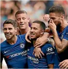  ??  ?? Left, Roberto Firmino and Mo Salah celebrate for Liverpool while Eden Hazard, of Chelsea, was the centre of the attention as they beat Cardiff 4-1.