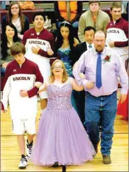  ?? MARK HUMPHREY ENTERPRISE-LEADER ?? Down Syndrome could not dash the dream of Kaylea Sandlin, daughter of Johnny and Susan Gilford, escorted by her father and senior Michael Eubanks, son of Charles and Sara Phillips, on her way to receiving the 2014 Lincoln Basketball Homecoming crown....