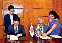  ??  ?? Fusato Tanaka Chief Representa­tive of JICA Sri Lanka Office and Dr. R Samaratung­a Secretary to Ministry of Finance & Mass Media sign the agreements