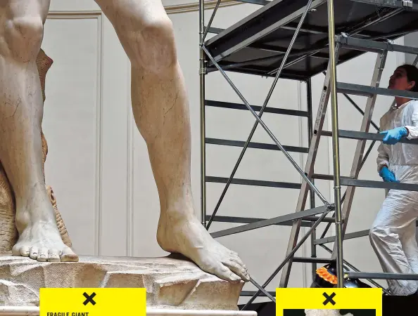  ??  ?? Even apart from his endangered ankles, the condition of David is far from pristine. The marble has become porous over the years as a result of weathering and bird feces during the three and a half centuries that the statue stood outside. FRAGILE GIANT