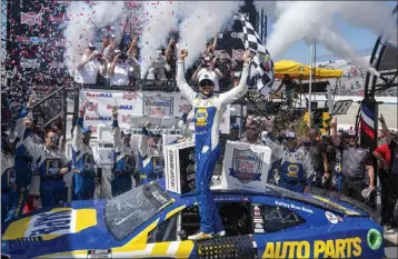  ?? JASON MINTO — THE ASSOCIATED PRESS ?? Chase Elliott celebrates in Victory Lane after winning the rain-delayed NASCAR race at Dover Motor Speedway on Monday.