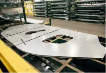  ??  ?? These blanks, cut from sheet steel, are Evoque side frames. The two holes will form the front and rear door openings, giving an idea of the extreme forces applied by the presses