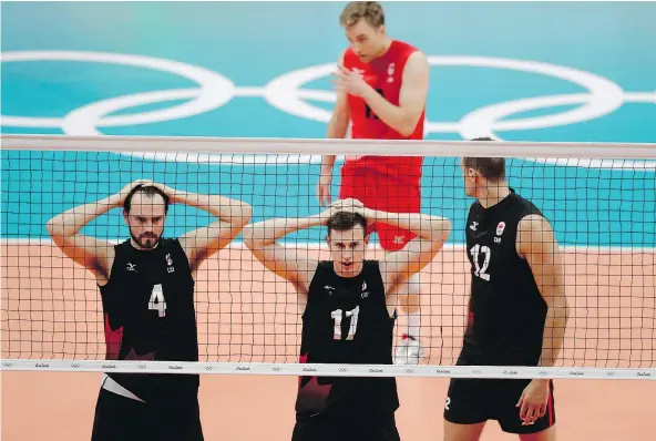  ?? — THE ASSOCIATED PRESS ?? From left, Canada’s Nicholas Hoag, Graham Vigrass, Gavin Schmitt, and, behind, Blair Cameron Bann, react during their quarter-final volleyball match against Russia on Wednesday. Canada lost in three straight sets, ending an exciting run.