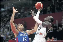  ?? [(AP PHOTO] ?? Dennis Schroder of Germany, right, goes up for a shot against Eulis Baez of Dominican Republic during a Group G match in the FIBA World Cup Tuesday in south China's Guangdong province.