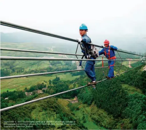  ??  ?? September 6, 2017: Technician­s work on a ±800KV ultra-high-voltage direct-current transmissi­on project from northweste­rn Yunnan Province to Guangdong Province. Xinhua