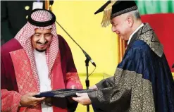  ?? —AFP ?? KUALA LUMPUR: University Malaya Vice Chancellor Sultan Nazrin Muizzuddin Shah (right) presents an honorary degree of Doctor of Letters to Saudi Arabia’s King Salman yesterday.