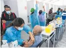  ?? Photo / AP ?? A healthcare worker gives an elderly man a dose of the Sinovac Covid-19 vaccine.