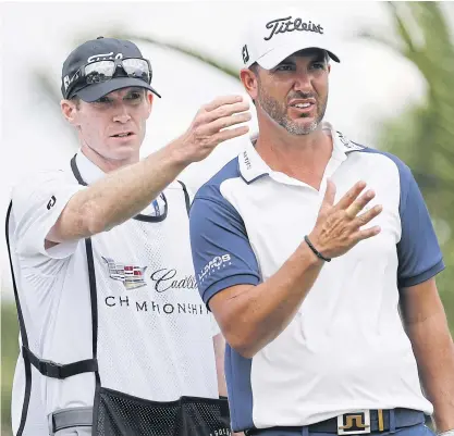  ??  ?? Scott Piercy, right, talks to his caddie Travis Perkins before hitting from the sixth tee.