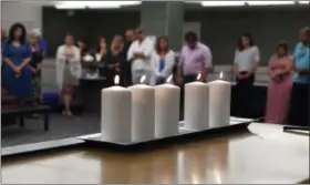  ?? JERRY JACKSON — THE BALTIMORE SUN VIA AP ?? Employees stand for a moment of silence in the Baltimore Sun newsroom, Thursday in Baltimore, Md., for the five colleagues of the Capital Gazette in Annapolis, Md., who were killed a week ago.