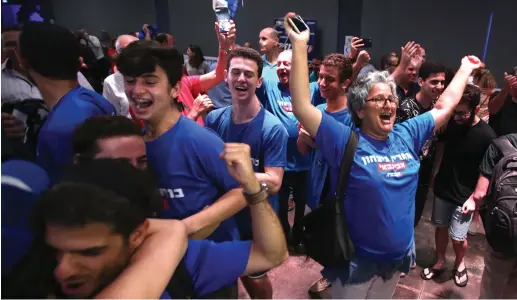  ?? (Marc Israel Sellem/The Jerusalem Post) ?? SUPPORTERS OF new Labor Party chairman Avi Gabbay celebrate the announceme­nt of his win at Tel Aviv Fairground­s last night.