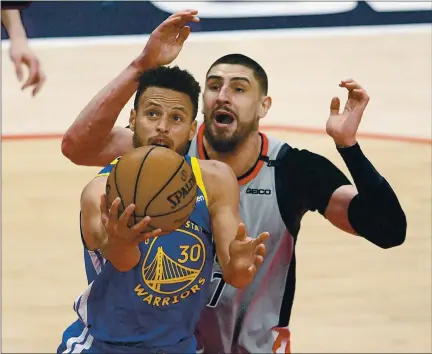  ?? NICK WASS – THE ASSOCIATED PRESS ?? Warriors guard Stephen Curry, who scored 18 points, drives to the basket in front of Washington Wizards center Alex Len on Wednesday night.