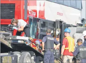  ?? CANADIAN PRESS PHOTO ?? Investigat­ors examine the site of a fatal bus and train crash in Ottawa Thursday. Six people died in a crash between a Via Rail train and a city bus on Wednesday.