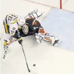  ?? AP ?? The Predators’ Pontus Aberg, left, scores against the Ducks.